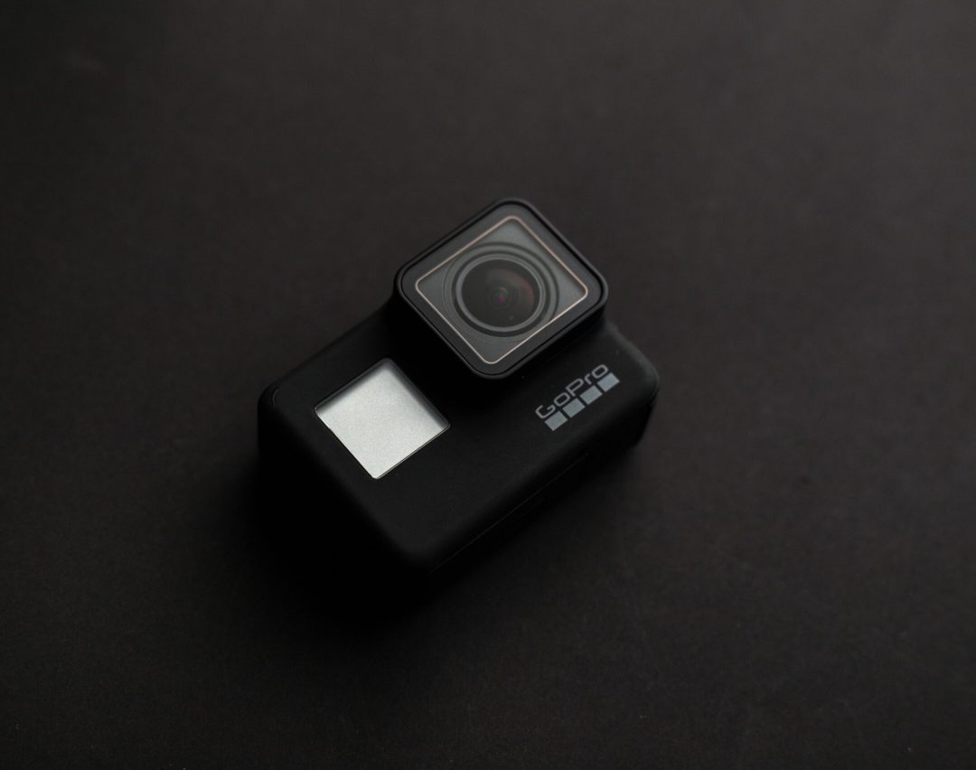 High-quality image of a GoPro camera on a dark surface, ideal for tech content.